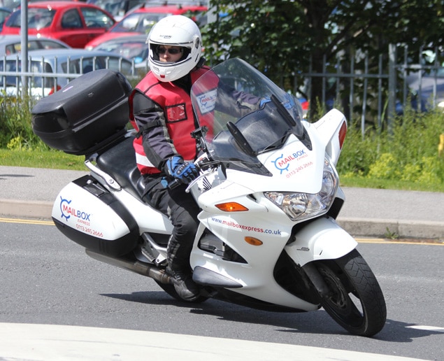 Man on motorbike with Mailbox Express branding